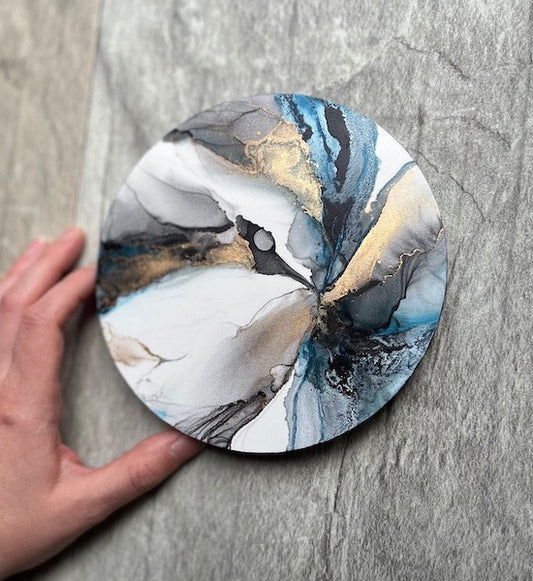 An abstract artwork with blue, black and gold colours. This original painting holds elements of ocean, storm and moon, expressing the transformative nature of menstrual phases.