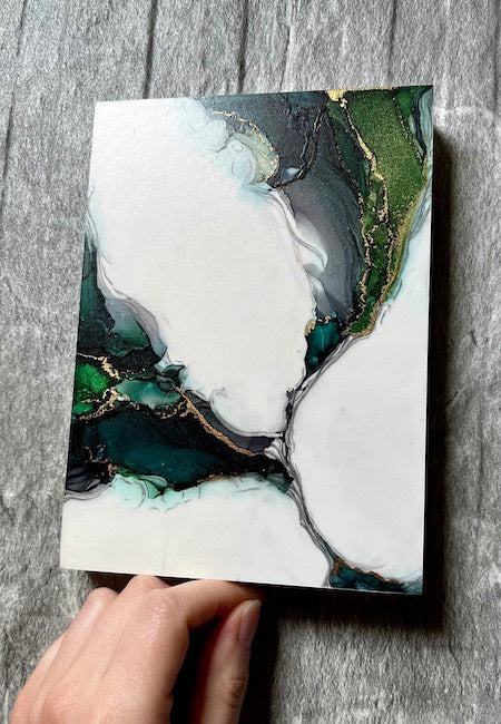 Dark green painting featuring hand painted fantasy dragon wings displayed on a stone wall. Original art for sale.