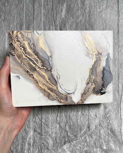Abstract wall art featuring alternative fantasy art of wings, hand painted in grey and gold shades in a marble stone technique to create a soft goth aesthetic.