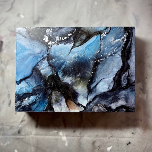Blue wall art abstract painting featuring colours of the ocean and moody black.