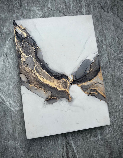 Fantasy art featuring gothic wings hand painted in grey and gold in a marble stone technique. Fantasy abstract art on a stone wall.