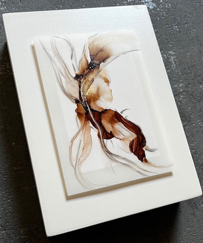 A nature spirit in brown, gold and grey colours, float mounted on a white panel. This abstract art with meaning is symbolic of retreat, the shedding of skin and of returning to the seat of the soul.