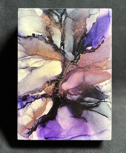Abstract space art of a supernova in purple and black, copper and white colours.