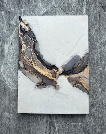Fantasy art featuring hand painted fantasy wing art in an abstract fantasy and surreal gothic aesthetic, displayed on grey stone.