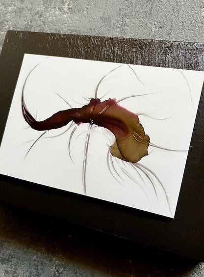 Symbolism art of decay and death hand painted in a dark aesthetic, featuring original art of a hybrid animal. This symbolic artwork is mounted on a black panel that has been hung on a grey wall.