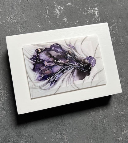 A hybrid animal in a dark aesthetic symbolic of transformation through depth, darkness and emotion. This original art comes mounted on a white panel to create contrast and is shown hung on an interior grey wall.