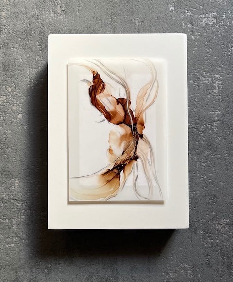Abstract wall art with surreal elements featuring a depiction of a nature spirit in flowing wood colours and lines on a grey wall.